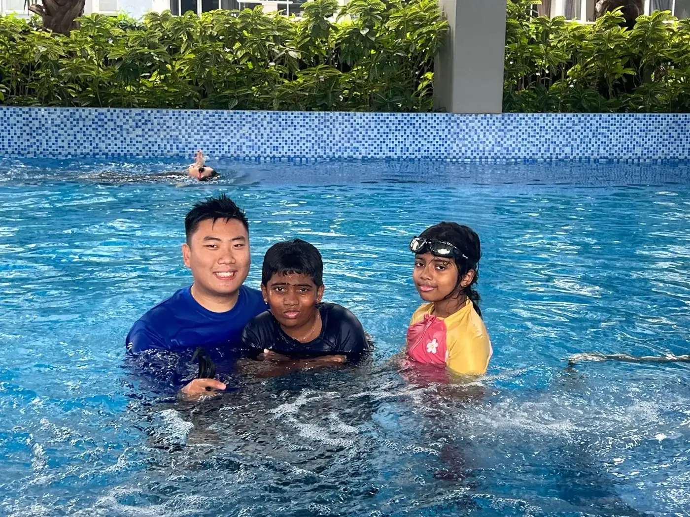 Penguin Swim School coach with young learners after a pool lesson