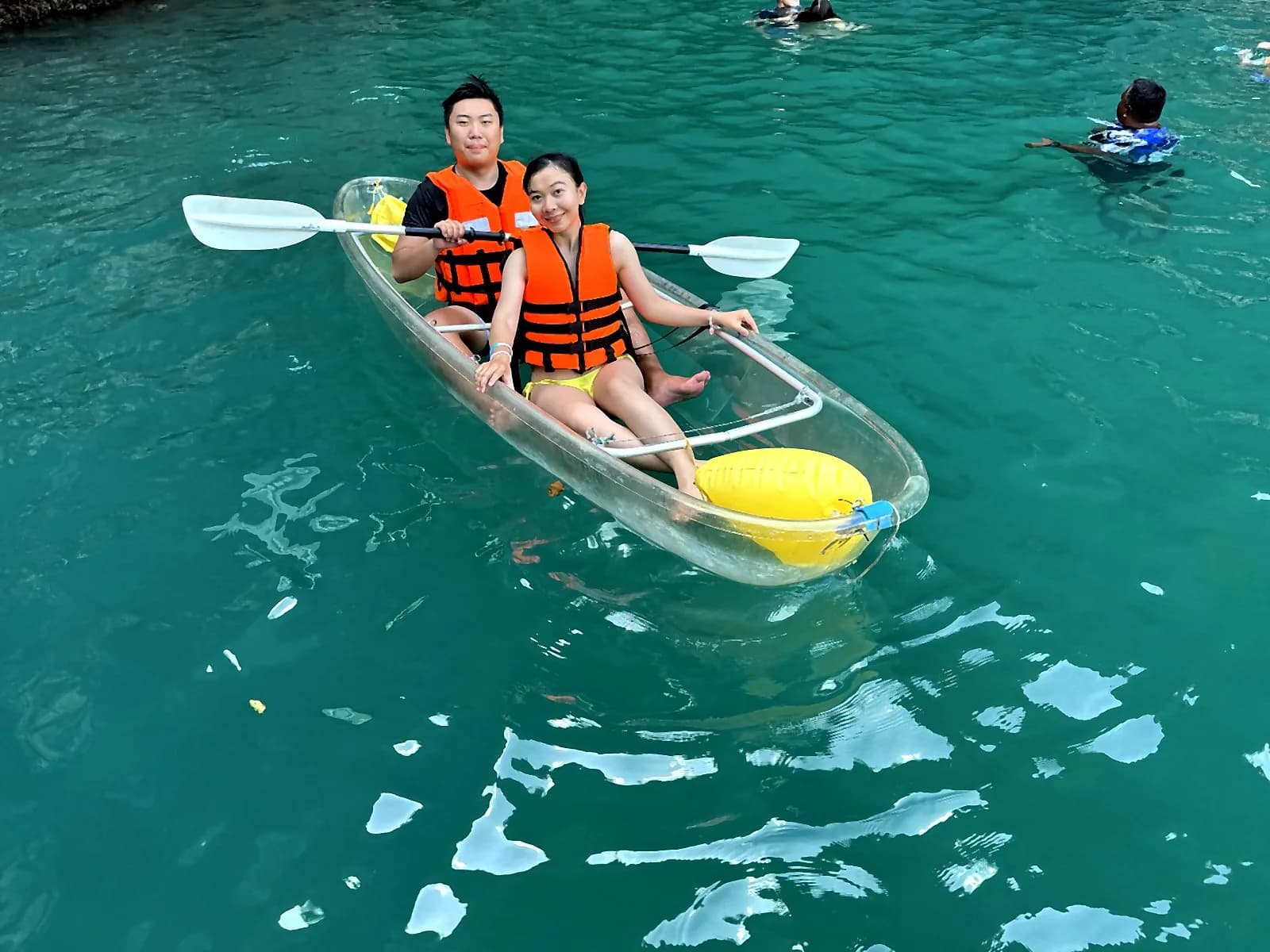 Rayner and Panita creating Thailand couple travel content on a clear kayak