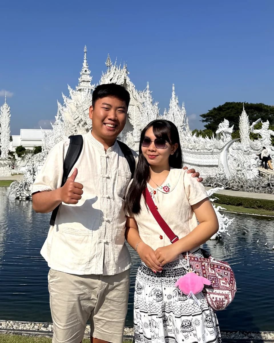 Rayner and Panita at the White Temple in Thailand for Singapore-Thailand couple storytelling