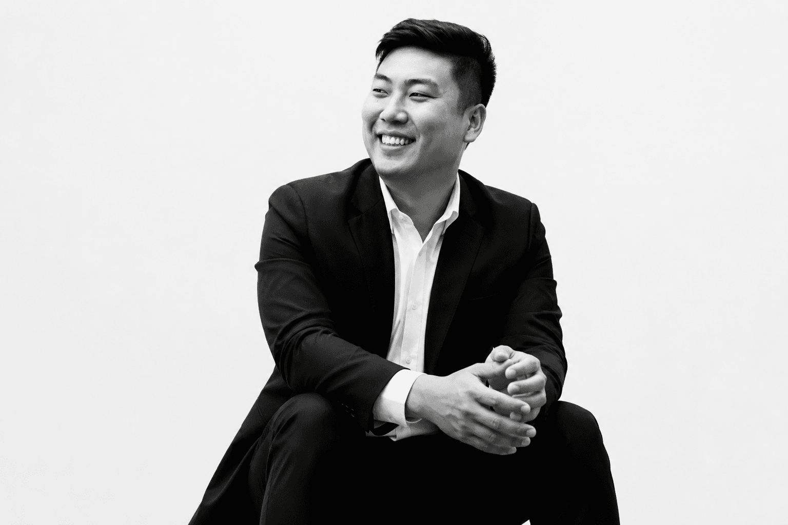 Rayner Teo seated in a black and white portrait photograph